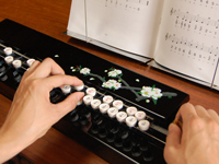 右手と左手を使っての大正琴の動作の画像